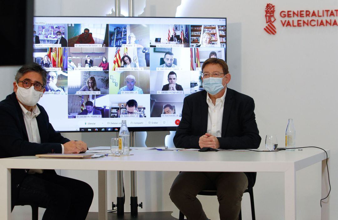 Ximo Puig con las imágenes de los alcaldes, entre ellos el de Alcoy, al fondo en una gran pantalla