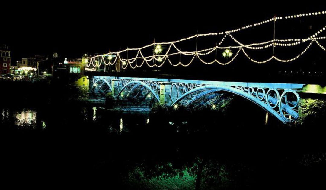Puente de Triana iluminado durante la Velá de Santa Ana