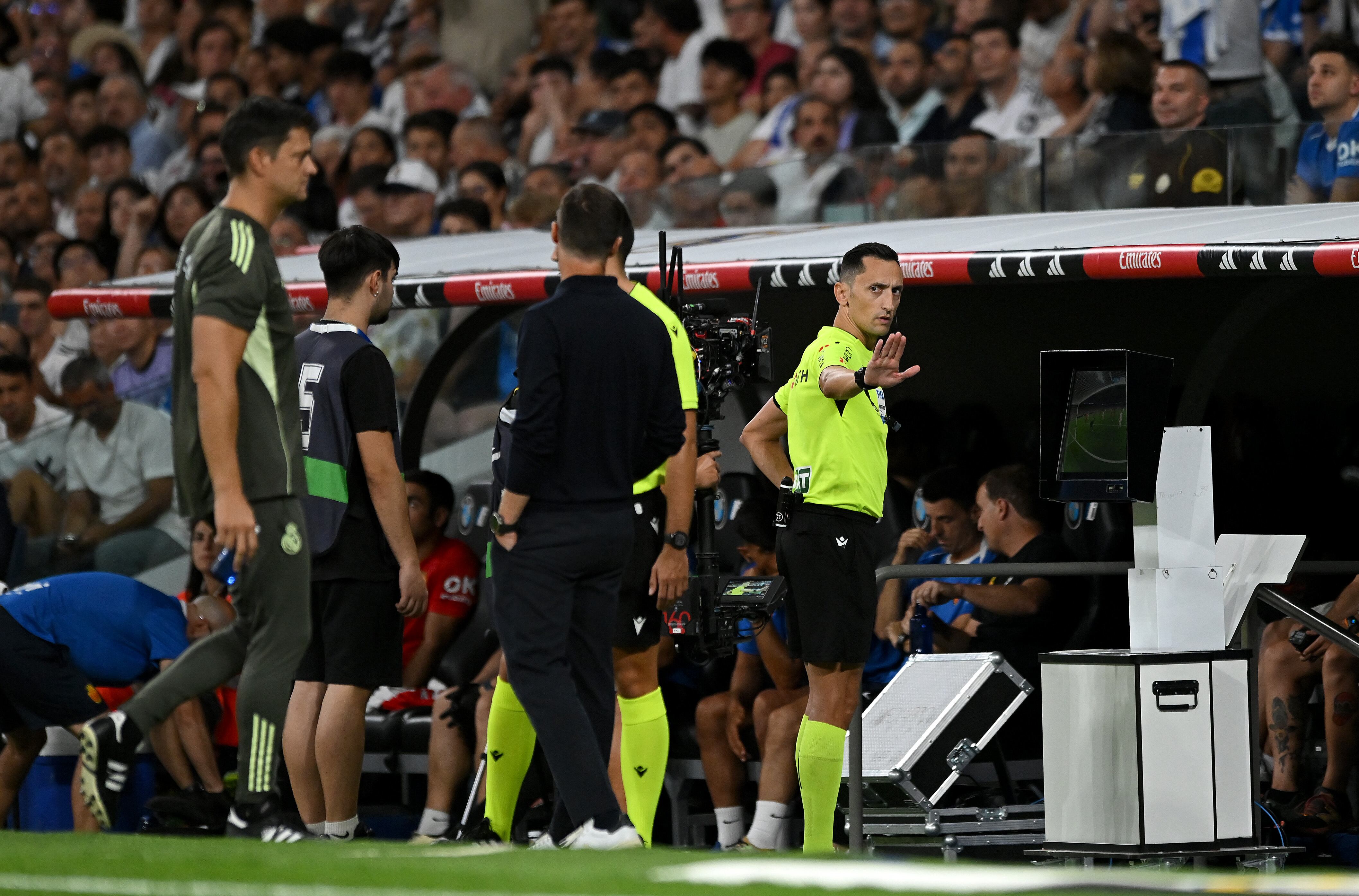 MADRID, SPAIN - AUGUST 30: Referee Jose Marea Sanchez Martinez checks the VAR screen after Arda Gueler of Real Madrid scored his side's third goal during the LaLiga EA Sports match between Real Madrid CF and RCD Mallorca at Estadio Santiago Bernabeu on August 30, 2025 in Madrid, Spain. (Photo by Denis Doyle/Getty Images)
