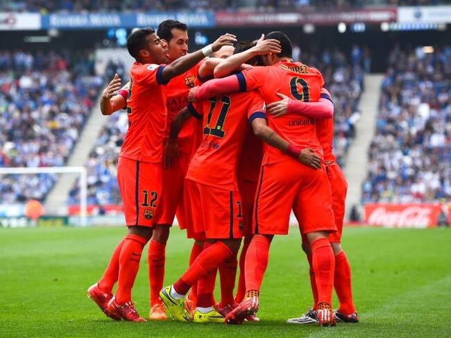 BARCELONA, SPAIN - APRIL 25: FC Barcelona players celebrate after Lionel Messi of FC Barcelona scored his team's second goal during the La Liga match between RCD Espanyol and FC Barcelona at Cornella-El Prat Stadium on April 25, 2015 in Barcelona, Spain.