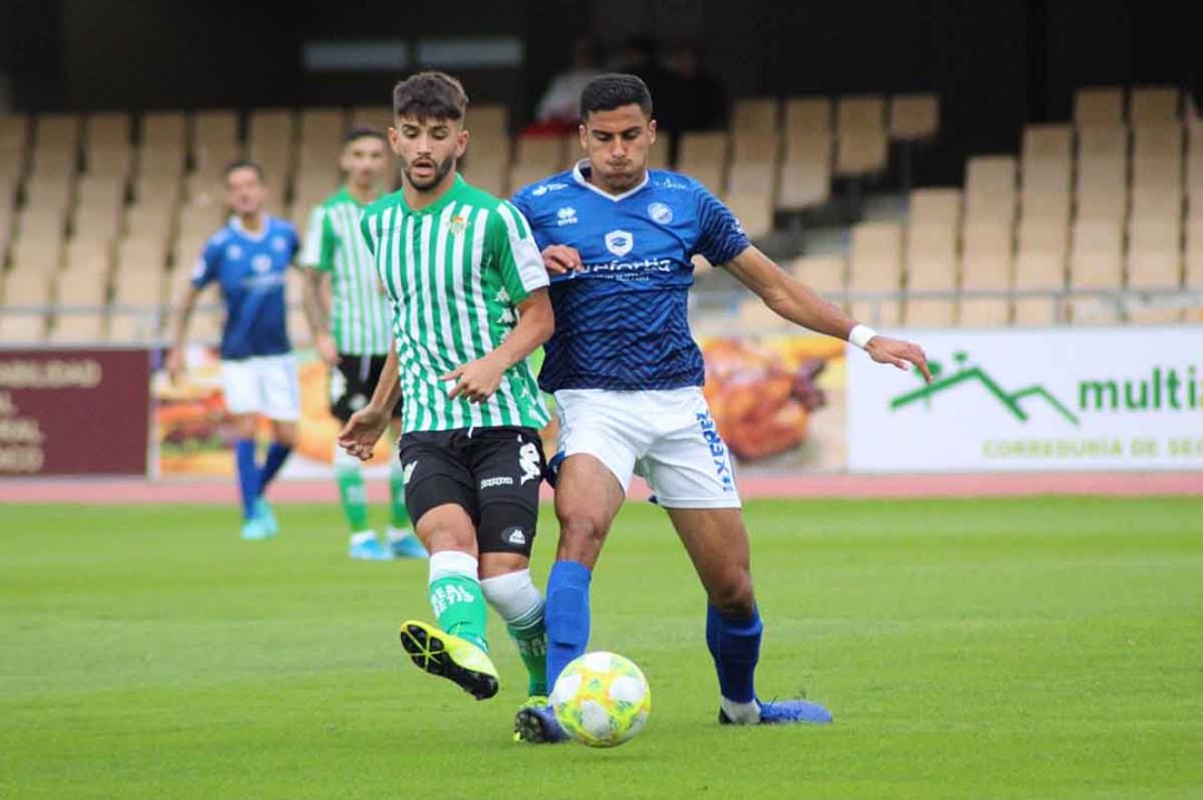 Amin disputando un balón con un jugador del Betis   