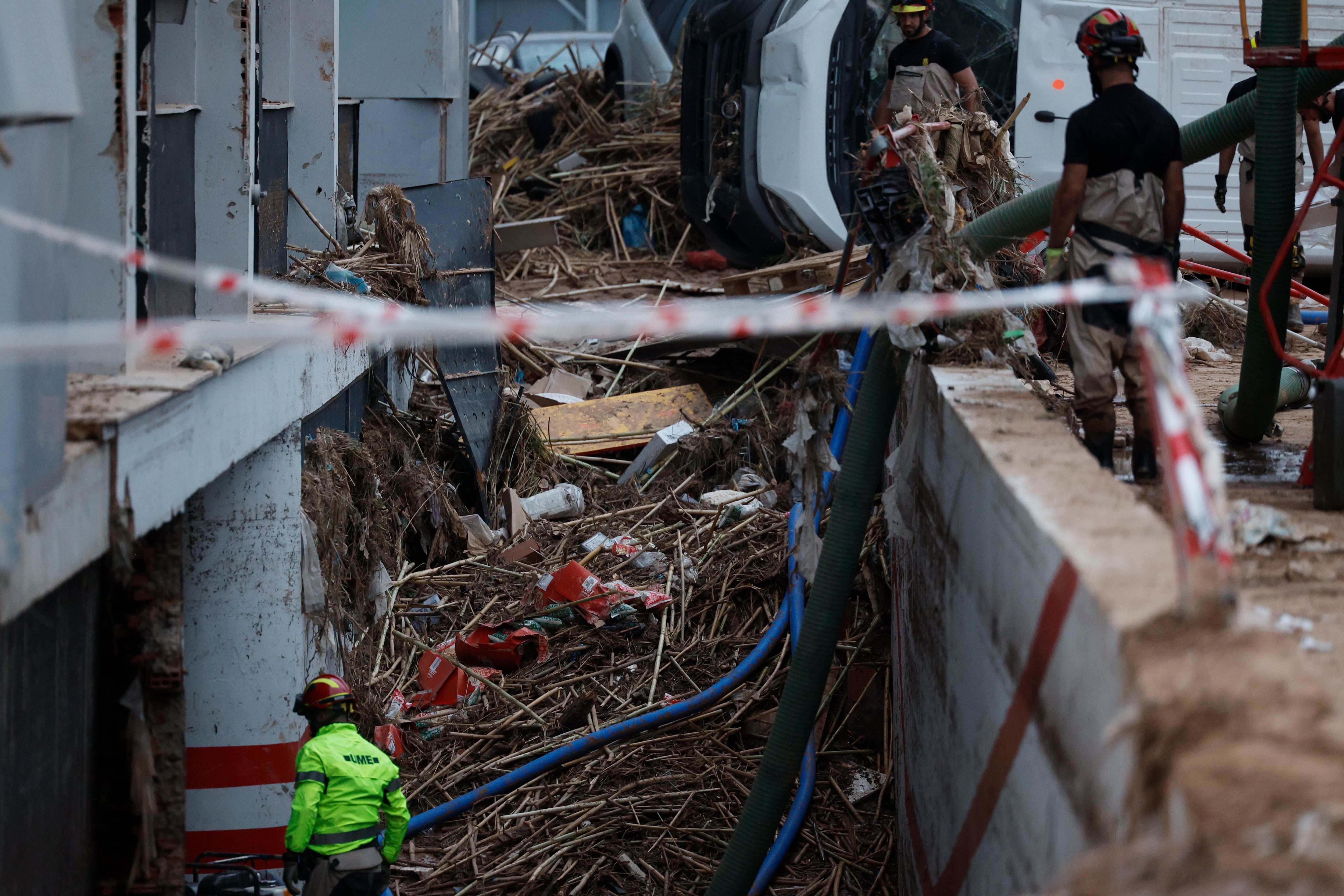 RIBARROJA DE TURIA (ESPAÑA), 31/10/2024.- Los bomberos achican agua de un subterráneo en un polígono industrial destrozado tras la DANA que asolado el sureste español y ha causado más de un centenar de muertos, este jueves, en Ribarroja de Turia (Comunidad Valenciana). EFE/Kai Försterling
