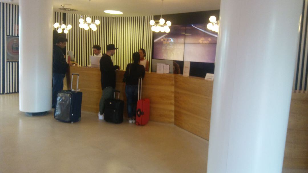 Turistas en la recepción de un establecimiento hotelero