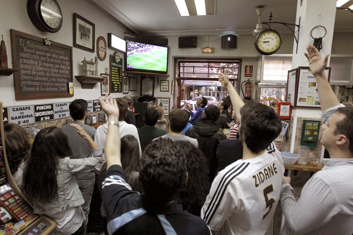 Aficionados al fútbol siguen el partido entre el FC Barcelona y el Real Madrid, en una imagen de archivo.