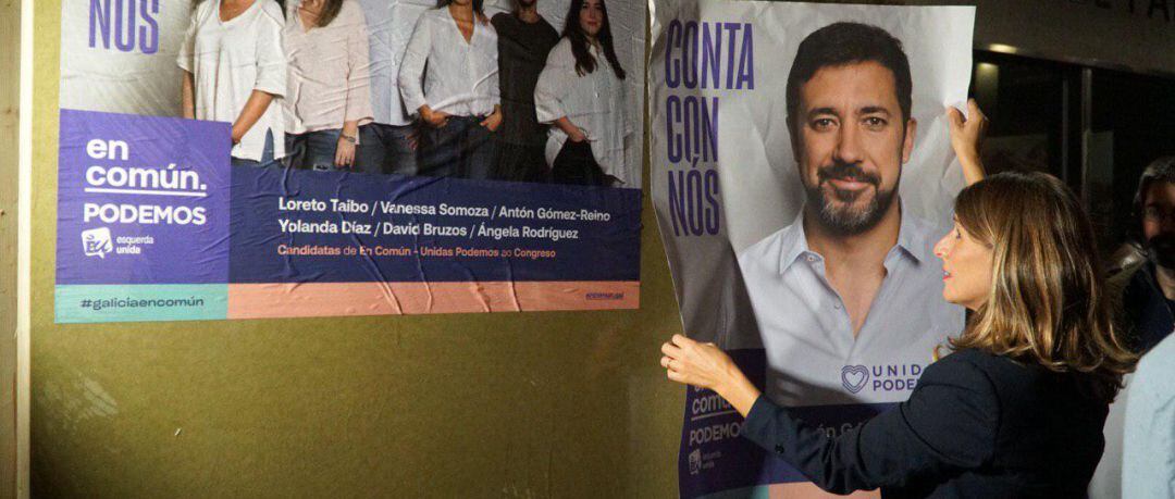 Yolanda Díaz (Izquierda Unida) coloca un cartel de Antón Gómez Reino (Podemos)