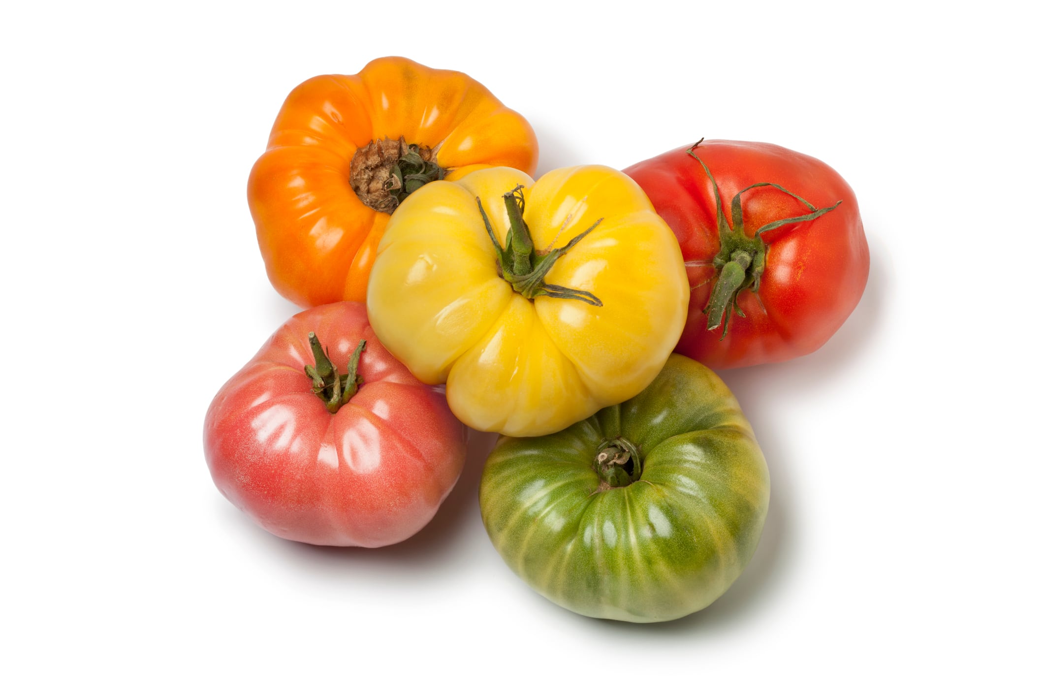 Diversity of whole Beefsteak Tomato on white background