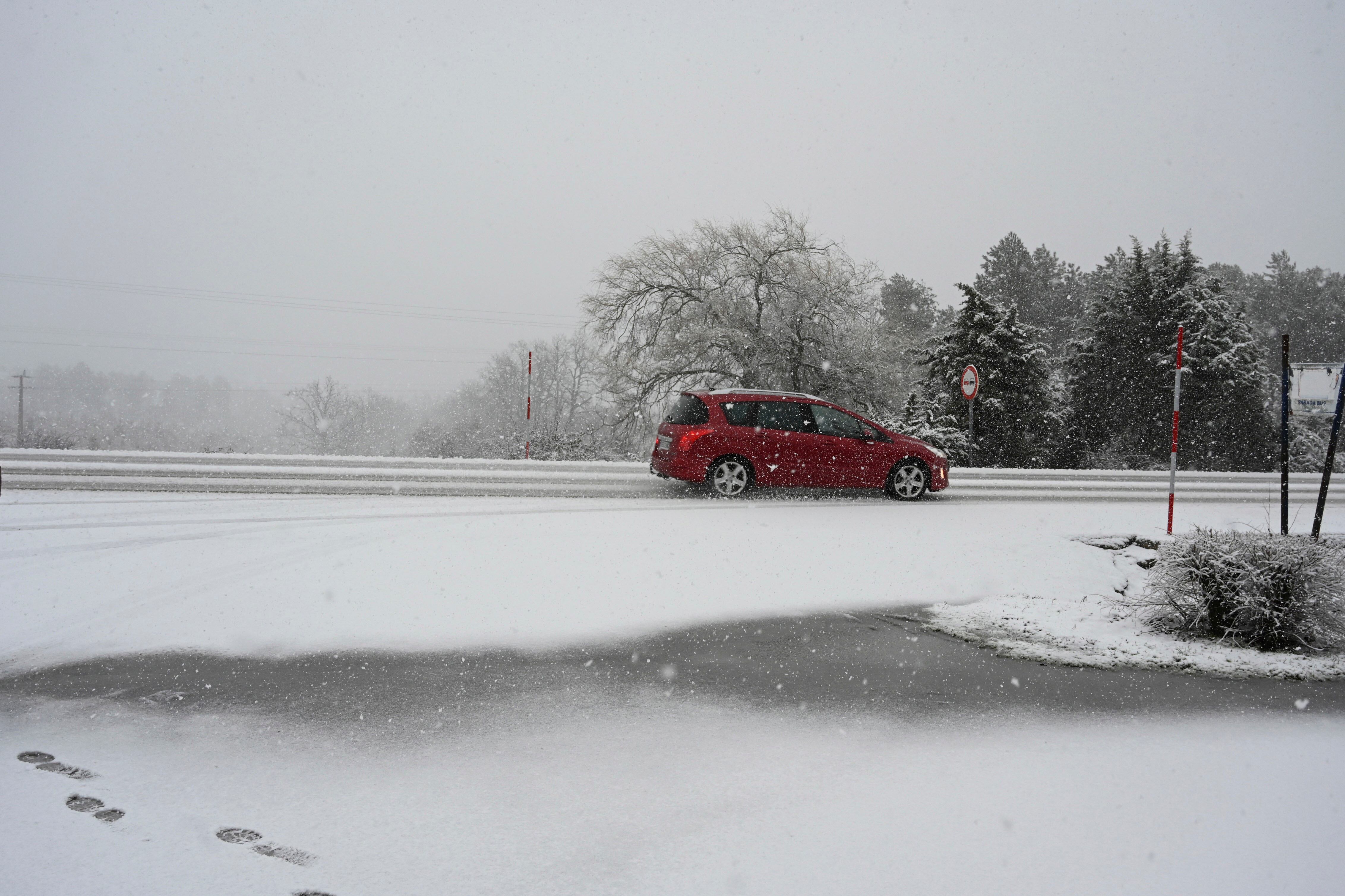 CARBAJAL (LEON), 07/02//2026.- Un coche transitaentre la nieve por la carretera N 630 este sábado en una jornada marcada por el temporal de nieve que afecta a varios puntos de la provincia de León. EFE/J.Casares