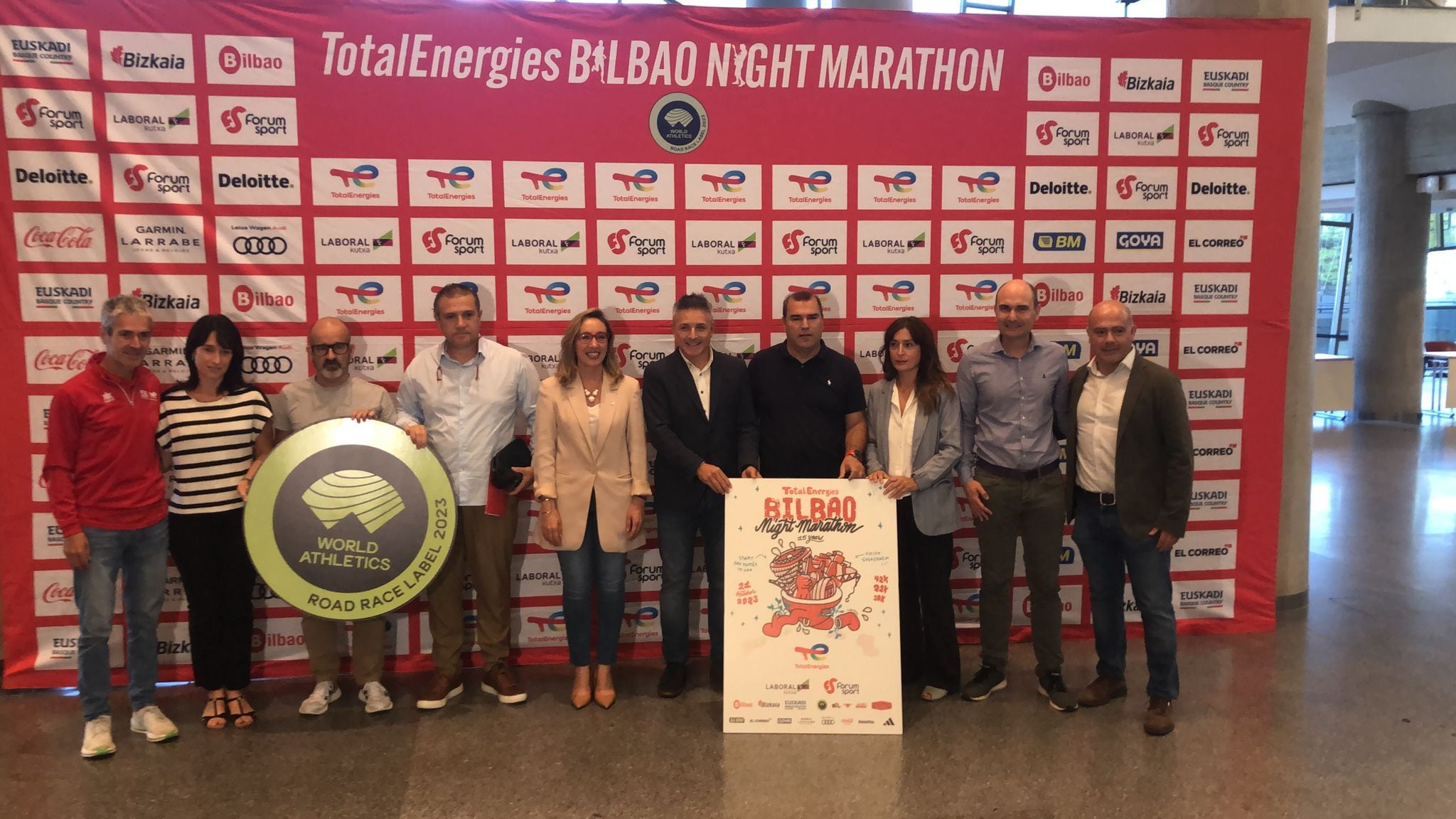 Instituciones y organización posan con el cartel de la 15ª edición de la Bilbao Night Marathon