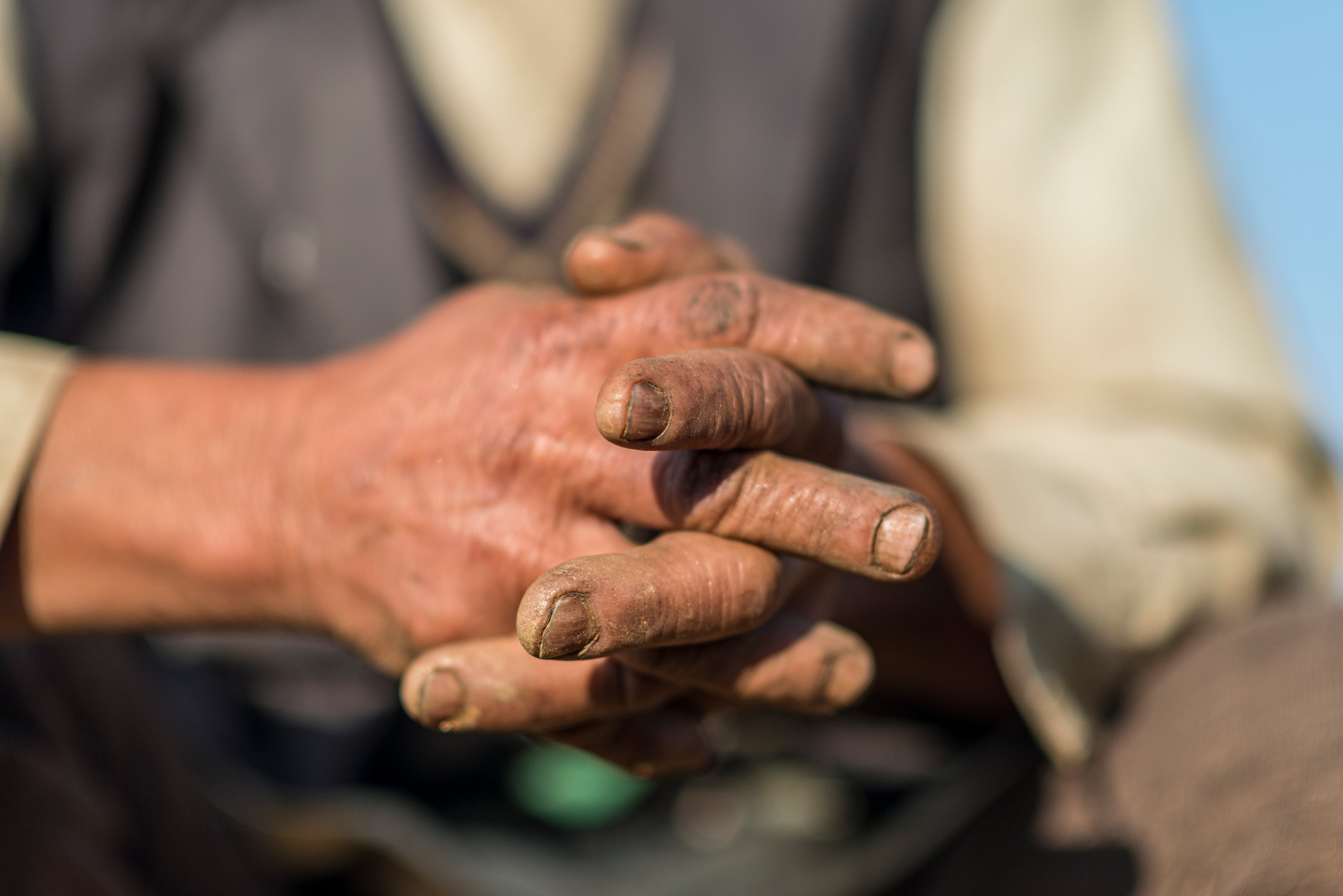 An old man in with hard working hands from Khotang district