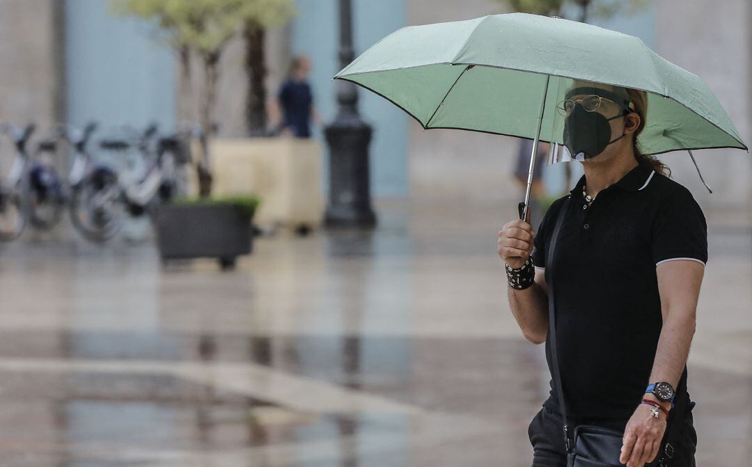 Una persona sostiene un paraguas mientras llueve, a 26 de julio de 2021, en Valencia, Comunidad Valenciana, (España).