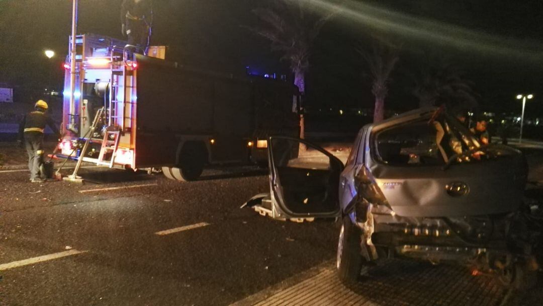 Los bomberos retirando los restos del vehículo accidentado.