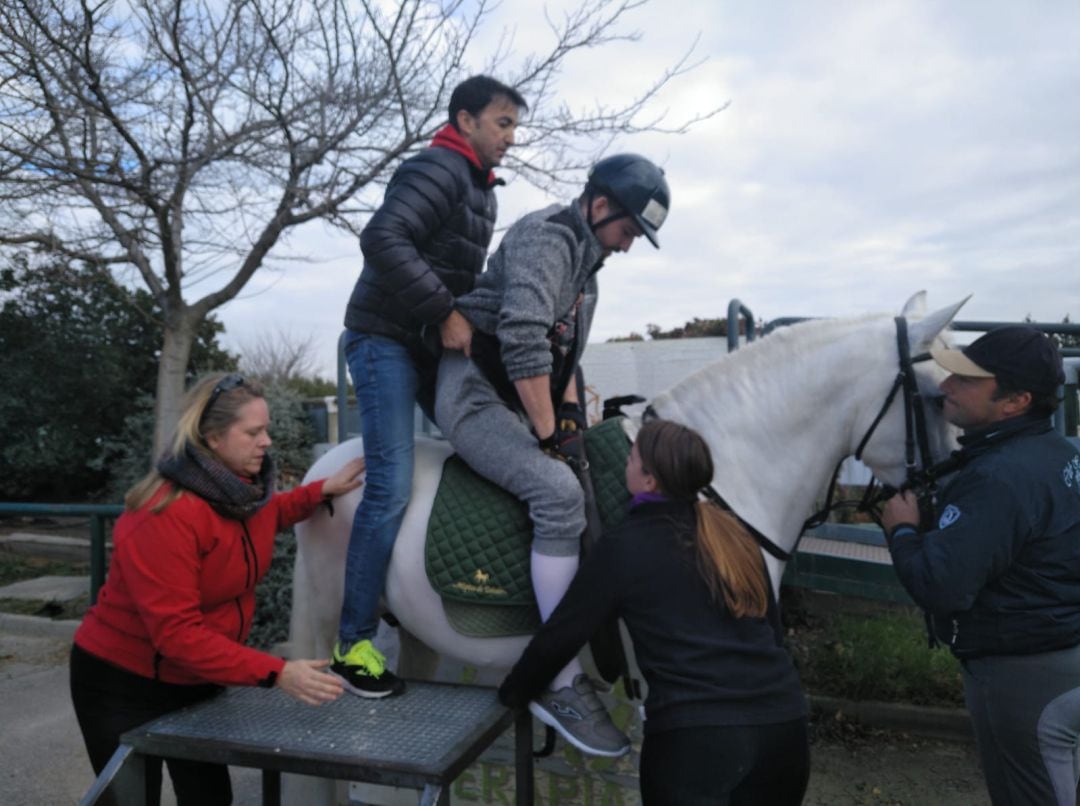 Victor sube al caballo Presu con ayuda de todo el equipo