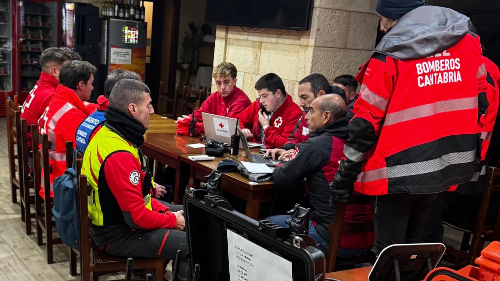 Miembros del Puesto de Mando Avanzado trabajan para coordinar las tareas de rescate que dieron con el cuerpo del piragüista en el agua, cerca de la orilla.